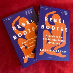two rebel bodies paperbacks lie next to each other on a red background.